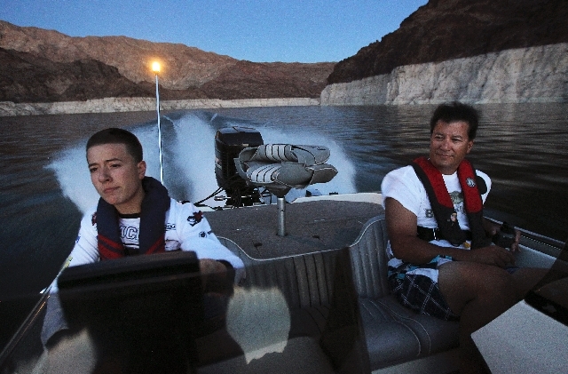 Zach Holt, left, steers a boat on Lake Mead with his father, Paul Holt, on Wednesday. Zach, 14, gained sponsorship to participate in next month's U.S. Open bass fishing tournament from Adoption Aw ...