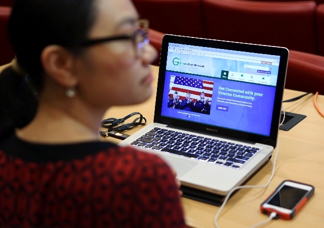 Green Zone Network, a website targeting nevadans to get connected with their veteran community, is viewed on a computer next to Charity Tran during the Green Zone Network summit at City Hall Wedne ...