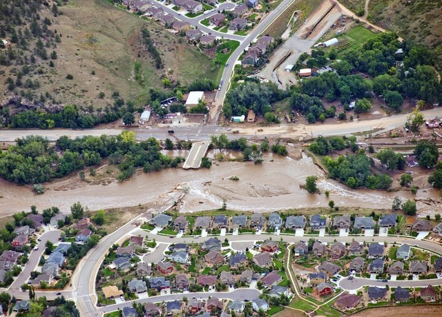 A residential neighborhood and a connecting road in Lyons, Colo., are cut in two by flood waters as flooding continues to devastate the Front Range and thousands are forced to evacuate with an unc ...