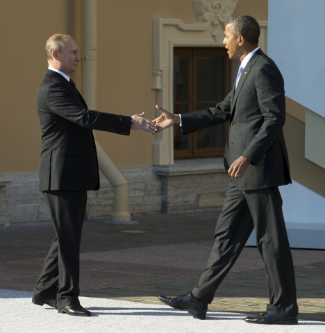 In this Sept. 5, President Barack Obama reaches to shakes hands with Russia's President Vladimir Putin during arrivals for the G-20 summit in St. Petersburg, Russia. (AP Photo/Pablo Martinez Monsi ...