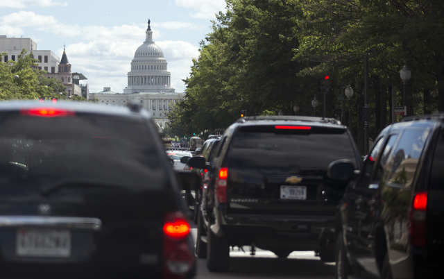 President Barack Obama's motorcade moves up Pennsylvania Ave. in the direction of the U.S. Capitol, center, Saturday, in Washington, en route to Andrews Air Force Base to golf. (AP Photo/Carolyn K ...