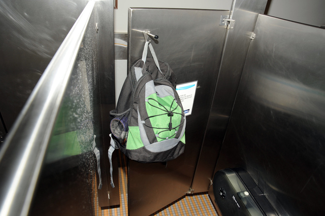 This image from video provided by the FBI, shows Aaron Alexis' backpack that was found hanging on the back of a bathroom stall door in the fourth-floor men's bathroom in building #197 at the Washi ...