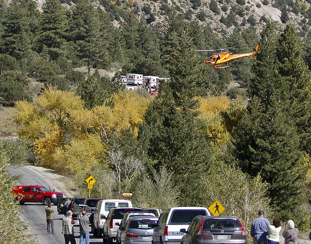 A Flight for Life Helicopter rises above backed up traffic Monday Sept. 30, 2013,  in south-central Colorado.  Roads were closed as emergency personnel work to  aid hikers trapped after a rock sli ...