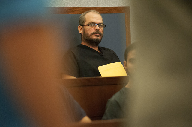 David Allen Brutsche, center, is seen in the courtroom for his preliminary hearing at the Regional Justice Center, Thursday, Sept. 26, 2013, in Las Vegas, Nev. Brutsche faces charges for conspirac ...