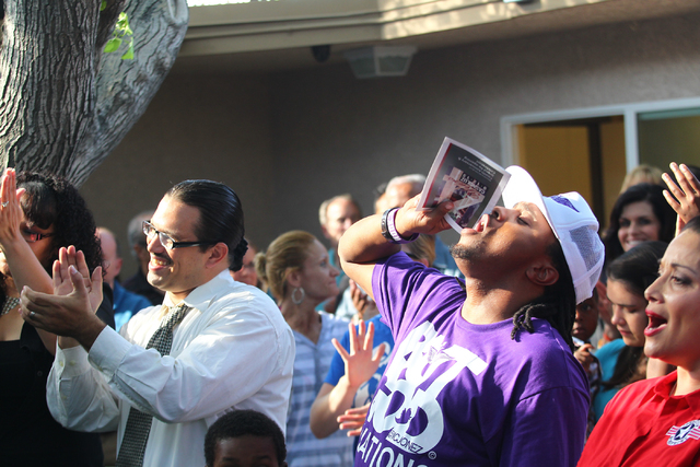Attendees cheer during the grand reopening and ribbon cutting ceremony at the Casa De Luz church in the Naked City area of Las Vegas on Thursday, Sept. 12, 2013. (Chase Stevens/Las Vegas Review-Jo ...