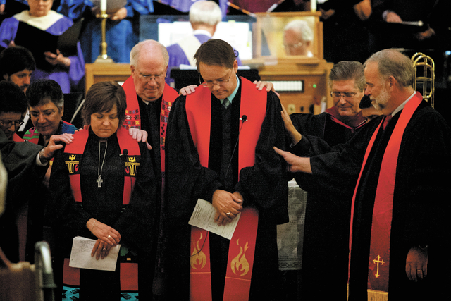 During the service, Rev. Jim Houston-Hencken, center, and Rev. Dana Pope, left, are formally installed as pastor and associate paster respectively at the newly formed Grace Presbyterian Church in  ...