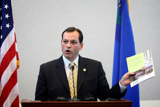 Joshua Ederheimer, U.S. Department of Justice Office of Community Oriented Policing Services office acting director, shows a copy of a six-month review of the Las Vegas Metropolitan Police Departm ...