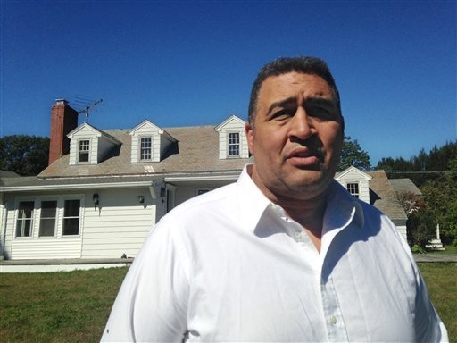 Former NFL offensive lineman Brian Holloway stands in front of his rural vacation home Wednesday, Sept. 18, 2013, in Stephentown, N.Y. Holloways rural vacation home was trashed during a Labor Day  ...