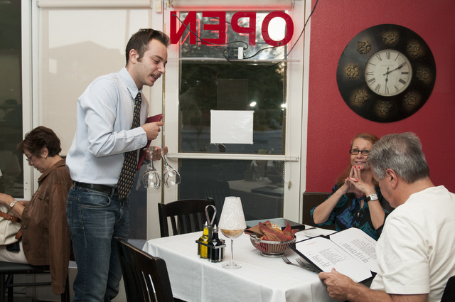 Riccardo Santamaria, left, co-owner of Gina's Bistro, is seen attending to customers during service, Saturday, Sept. 21, 2013, in Las Vegas, Nev. (Erik Verduzco/Las Vegas Review-Journal)