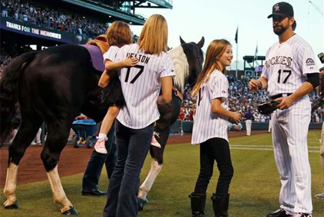 After being given a gelding paint horse  as a retirement present, Colorado Rockies first baseman Todd Helton, right, joins his daughter Tierney Faith, second from right, and his wife Christy and d ...