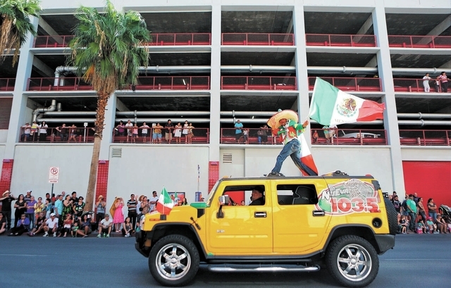 Radio personality El Peladillo waves a flag during the Fiesta Las Vegas Latino Parade Saturday, Sept. 14, 2013, in Las Vegas. The parade, which traveled north on 4th Street downtown past the Fremo ...