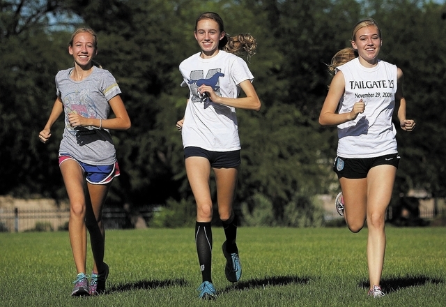 The Meadows’ Gosse triplets — from left, Bailey, Delaney and Cassidy — shown Friday before practice, are two-time winners, along with Jeneke Heerema, of the 3,200-meter relay in state track. ...