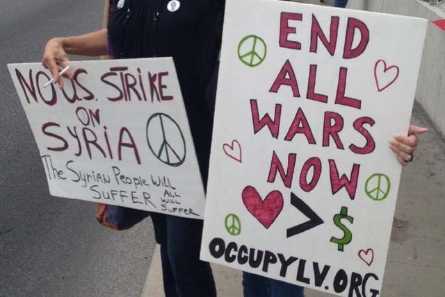 As the United States inches closer on a decision to go to war with Syria, local protesters rallied over the Tropicana overpass on Interstate 15 Saturday morning for the second straight week. On th ...