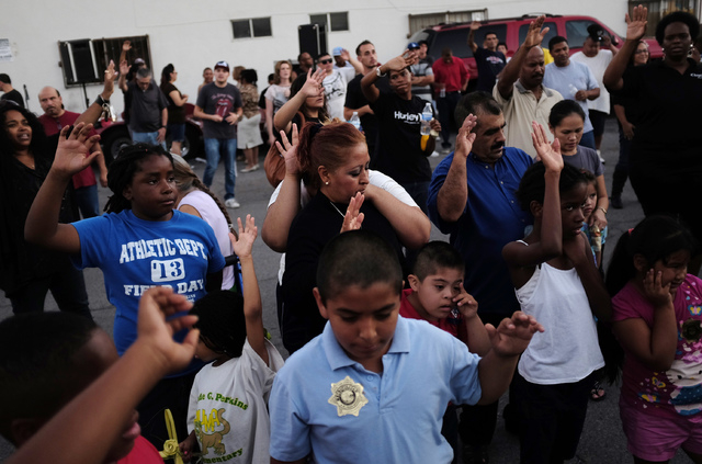 People pray during a Stop the Violence Rally in Las Vegas Friday, Sept. 13, 2013. (John Locher/Las Vegas Review-Journal)