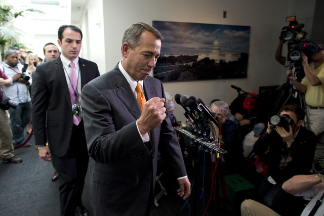 Speaker of the House Rep. John Boehner, R-Ohio, pumps his fist as he walks past reporters after a meeting with House Republicans on Capitol Hill on Wednesday, Oct. 16, 2013 in Washington. The part ...