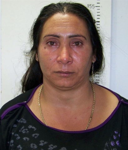In this police handout photo taken on Thursday , Oct. 17, 2013, Greek Roma, Eleftheria Dimopoulou, 40, or Selini Sali a woman who has two separate sets of identity papers. is seen in the Larisa ...