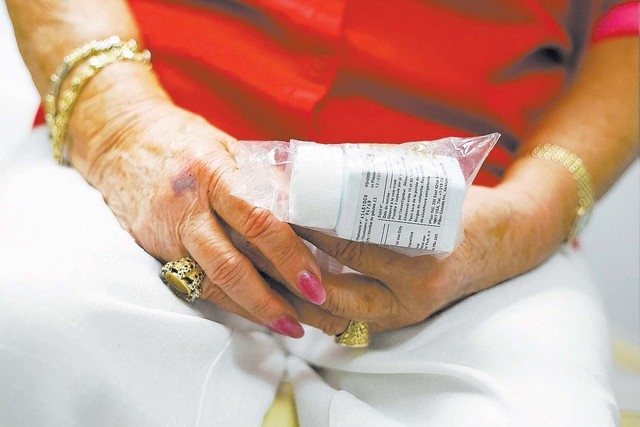 Mary Ann Hoban, 83, holds her breast cancer trial drugs, Pfizer, while at an appointment at Comprehensive Cancer Centers of Nevada on Friday, Sept. 20, 2013. Hoban began participating in the trial ...