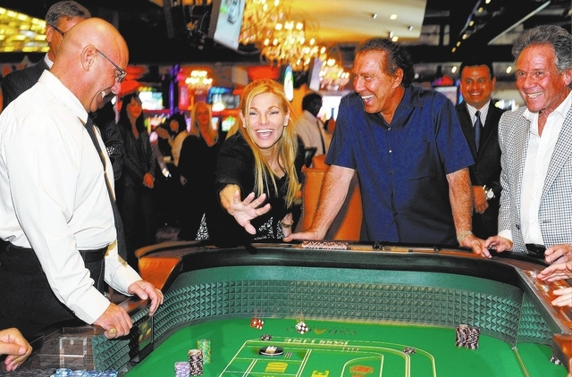 Andrea Wynn throws out the first dice after her husband, Steve Wynn, placed the first bet on the opening day of the Downtown Grand Las Vegas hotel-casino on Sunday, Oct. 27, 2013. (David Becker/La ...
