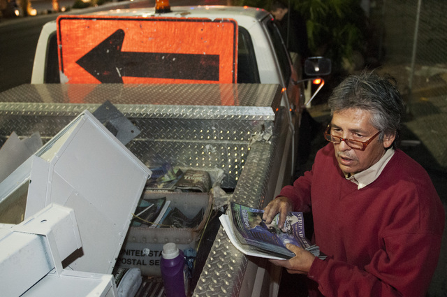 Eddie Munoz, owner of Strip Advertising, grabs magazines from his truck to refill news racks located on Las Vegas Boulevard near Circus Circus Hotel in Las Vegas, Thursday, Oct. 24, 2013. An ordin ...