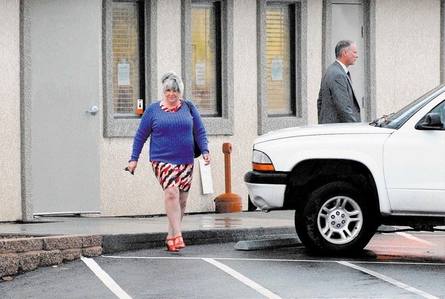 Nye County Assessor Shirley Matson leaves her office with the FBI in tow Wednesday. (Horace Langford Jr. / Pahrump Valley Times)