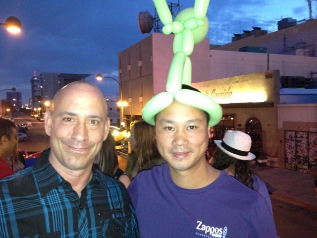 Tony Hsieh wears a balloon hat in downtown Las Vegas. At left is Michael Morton, co-owner of La Comida. (Norm Clarke photo)