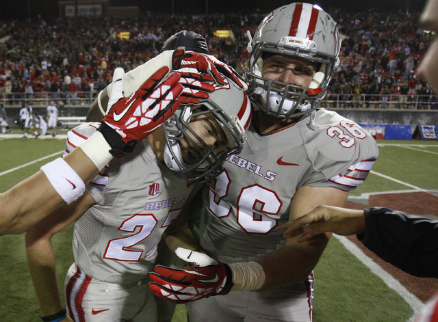 UNLV players congratulate Nolan Kohorst, left, after he scored the game winning field goal against Hawaii at Sam Boyd Stadium in Las Vegas Saturday, Oct. 12, 2013. (AP Photo/Las Vegas Review-Journ ...