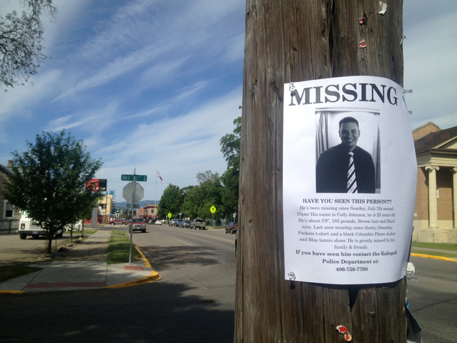 This July 12, 2013 photo, a flyer seeking information regarding Cody Lee Johnson is posted on a Kalispell, Mont., street corner. Johnson's newlywed wife, Jordan Graham, testified Friday that she i ...