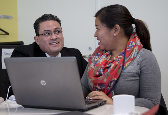 Principal Jorge Delgado talks with student Ana Rodriguez-Perez, right, during a General Educational Development (GED) test preparation class at the Sonia Gutierrez Campus of the Carlos Rosario Int ...