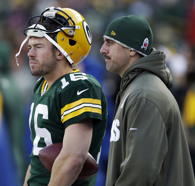 Green Bay Packers' Aaron Rodgers and Scott Tolzien watch from the sidelines during the second half of an NFL football game against the Philadelphia Eagles Sunday, Nov. 10, 2013, in Green Bay, Wis. ...