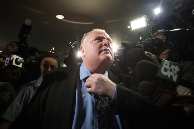 Toronto Mayor Rob Ford makes his way to the council chamber in Toronto on Friday, Nov. 15, 2013. (AP Photo/The Canadian Press, Chris Young)
