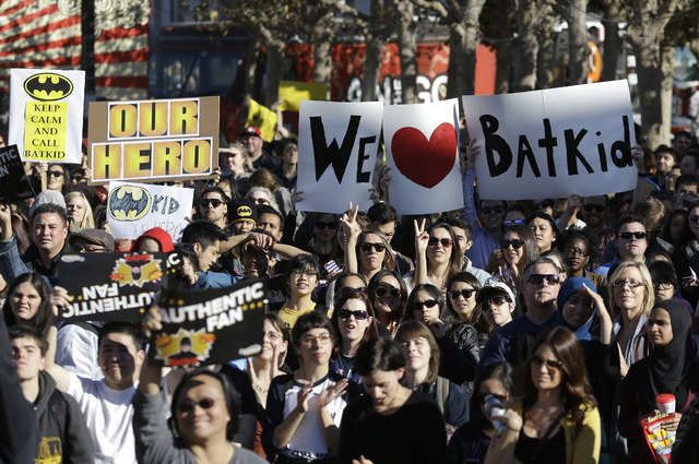A crowd holds up signs for Miles Scott, as Batkid, at a rally outside of City Hall in San Francisco, Friday, Nov. 15, 2013.  (AP Photo/Jeff Chiu)