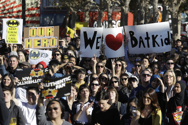 A crowd holds up signs for Miles Scott, as Batkid, at a rally outside of City Hall in San Francisco, Friday, Nov. 15, 2013. (AP Photo/Jeff Chiu)