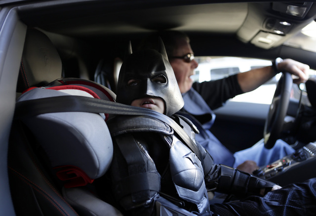 Miles Scott, 5, dressed as Batkid, waits in a Lamborghini "Batmobile" as he and Batman get ready to stop a bank robbery in San Francisco, Friday, Nov. 15, 2013. (AP Photo/Bay Area News Group, Gary ...