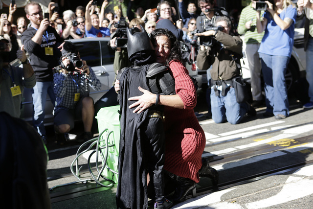 Miles Scott, 5, dressed as Batkid, rescues a damsel in distress in San Francisco, Friday, Nov. 15, 2013. (AP Photo/Bay Area News Group, Gary Reyes)
