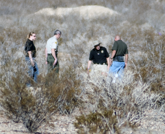 Forensic anthropologists and San Bernardino County Sheriff Department officials investigate two shallow graves where human remains were found in a remote area of Southern California's Mojave Deser ...