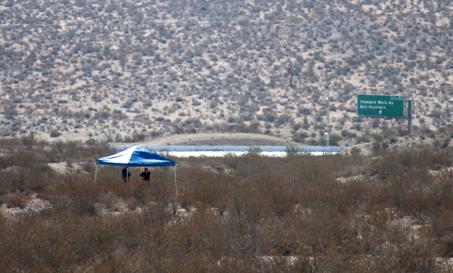 Forensic anthropologists and San Bernardino County Sheriff Department officials investigate two shallow graves where human remains were found in a remote area of Southern California's Mojave Deser ...