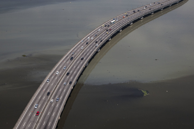 The polluted waters of Guanabara Bay float below a road leading to the international airport that serves Rio de Janeiro, Brazil, Tuesday, Nov. 19, 2013. Leonardo Gryner, chief operating officer of ...