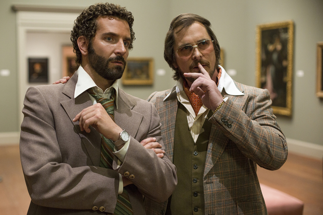 Richie Dimaso (Bradley Cooper, left) and Irving Rosenfeld (Christian Bale) talk in a gallery at the Frick Museum in Columbia Pictures' AMERICAN HUSTLE.