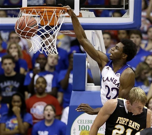 Kansas' Andrew Wiggins (22) gets past Fort Hays State's Jake Stoppel to dunk the ball during the second half of an exhibition NCAA college basketball game Tuesday, Nov. 5, 2013, in Lawrence, Kan. ...