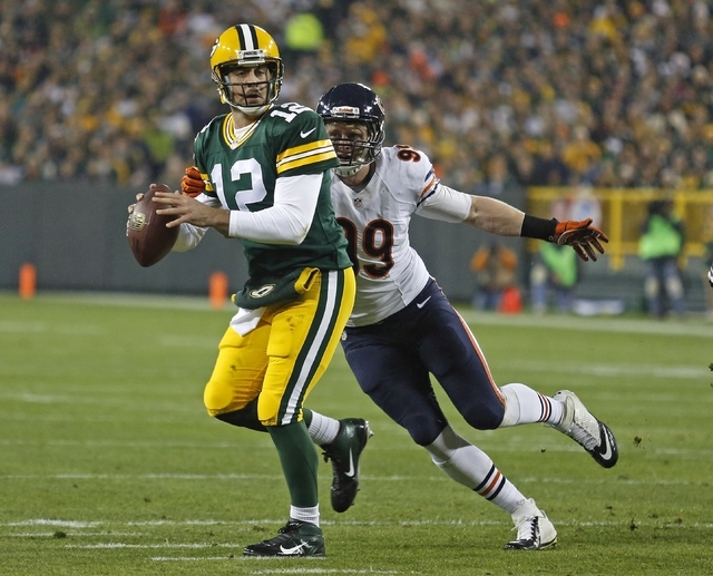 Green Bay Packers quarterback Aaron Rodgers gets sacked by Chicago Bears defensive end Shea McClellin during an NFL football game Monday, Nov. 4, 2013, in Green Bay, Wis. (AP Photo/Matt Ludtke)