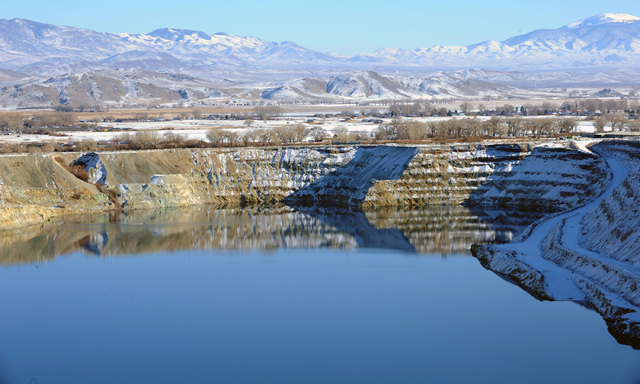 In this April 14, 2009 photo, the old Anaconda mine pit is partially filled with water near Yerington. Rural neighbors of an abandoned World War II-era copper mine that has leaked toxic chemicals  ...