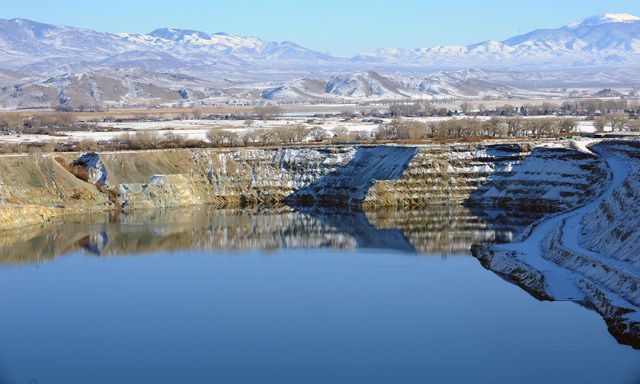 In this April 14, 2009 photo, the old Anaconda mine pit is partially filled with water near Yerington. Rural neighbors of an abandoned World War II-era copper mine that has leaked toxic chemicals ...