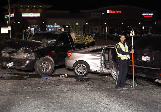 Nevada Highway Patrol officers investigate a crash at the corner of Blue Diamond Road and Cimarron Road in Las Vegas Thursday. The crash happened during a vigil for 14-year-old Helen Liu who was k ...