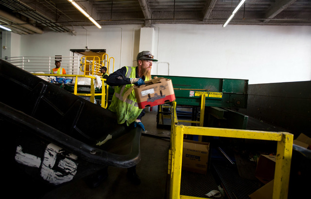 Glen Cooper of Republic Services recycles cardboard at Mandalay Bay Resort and Casino on Thursday. Traditional items like glass, paper and plastic are recycled from the hotel waste bins, while gre ...