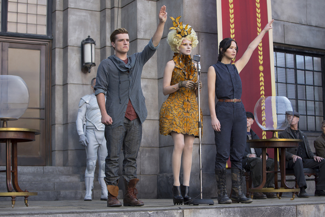 Katniss Everdeen (Jennifer Lawrence, right), Effie Trinket (Elizabeth Banks, center) and Peeta Mellark (Josh Hutcherson, left) in "The Hunger Games: Catching Fire." (MURRAY CLOSE/LIONSGATE)