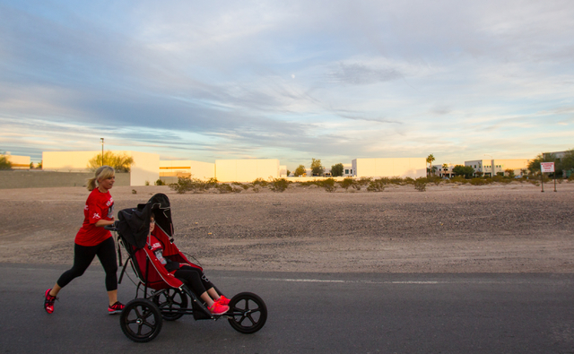 Eden Capsouto pushes her daughter, 20-year-old Taylor Little, in a jogging stroller on Arville Street near Sunset Road on Thursday during preparation for the Rock ‘n’ Roll Las Vegas Half-Marat ...
