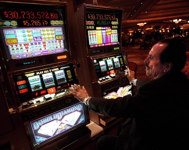 Lalo Goday, 66, from Orange County, California, plays two Megabucks machines at once at Mandalay Bay. (File, JEFF SCHEID/LAS VEGAS REVIEW-JOURNAL)