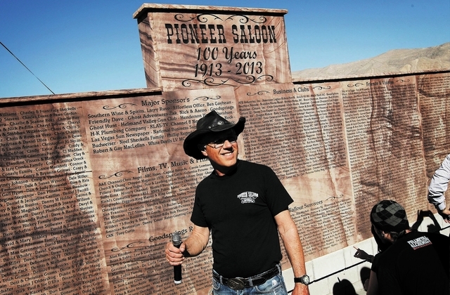 Owner Noel Sheckells unveils a new monument commemorating the 100th birthday of the Pioneer Saloon in Goodsprings on Oct. 19. (Jason Bean/Las Vegas Review-Journal)