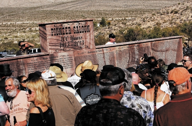 Patrons check out a new stone monument marking the 100th birthday of the Pioneer Saloon in Goodsprings on Oct. 19. (Jason Bean/Las Vegas Review-Journal)