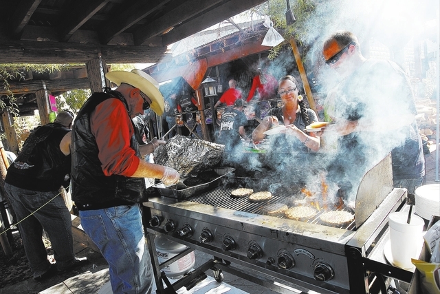 Saloon employee Geary Hewett, left, grills burgers for hungry patrons during the 100th birthday celebration for the Pioneer Saloon in Goodsprings on Oct. 19, 2013. (Jason Bean/Las Vegas Review-Jou ...